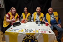 Lions Cat, Jim, Clive and volunteer selling beer tickets at ComedyFest.